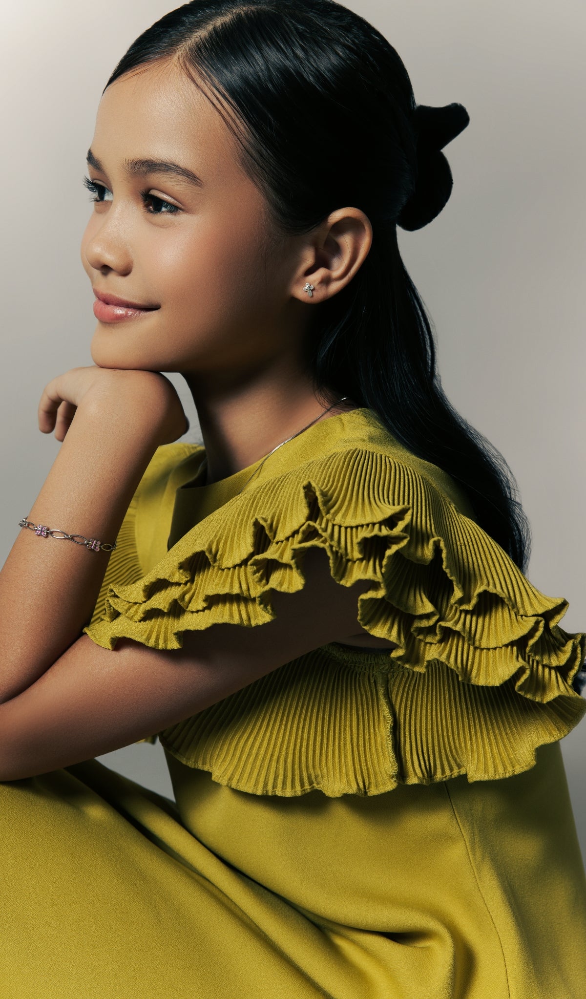 Model wearing Blue Francis bracelet with pink and silver details, styled with a yellow ruffled dress, featured in the Homepage Shop Bracelet section.