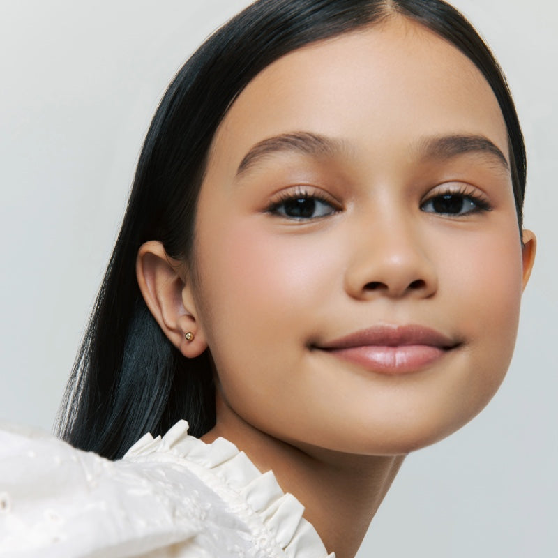 Soho Ball Studs - 14K Gold Earrings used by child model with neutral background