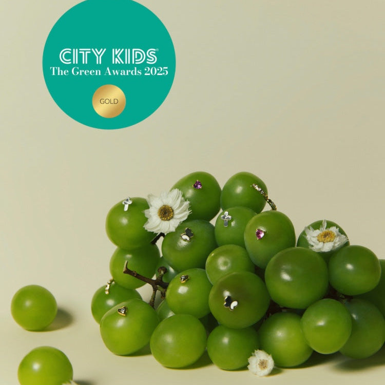 A picture of Blue Francis Earrings in Green Grapes with City Kids The Green Awards 2025 medal in Gold