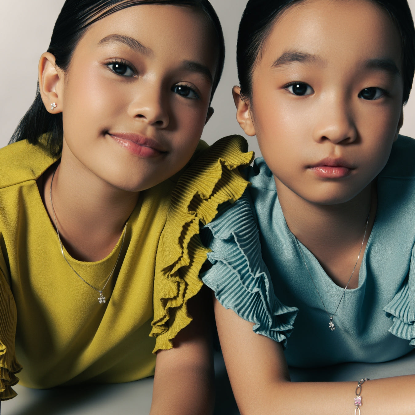 TTwo children in pastel tops wearing silver jewelry — Brooklyn Unicorn Necklace, Blue Francis