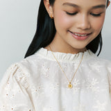 Blue Francis - child model is wearing Cross Twinkle Necklace made in Vermeil 