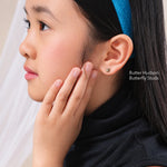 Girl wearing Butter Hudson Butterfly Studs, gold butterfly stud earrings for girls