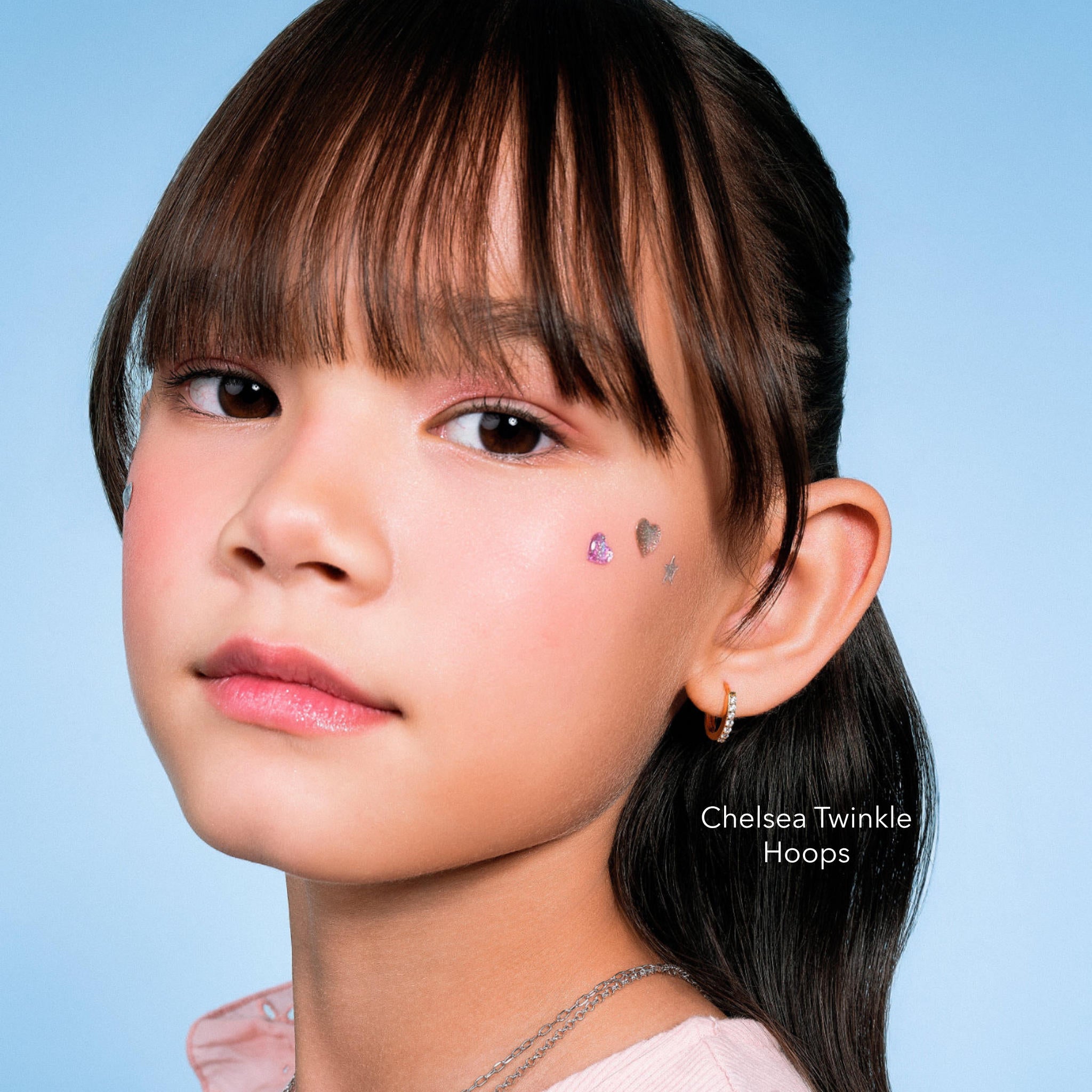 Girl wearing Chelsea Twinkle Hoops, 18K gold vermeil kids hoop earrings with cubic zirconia