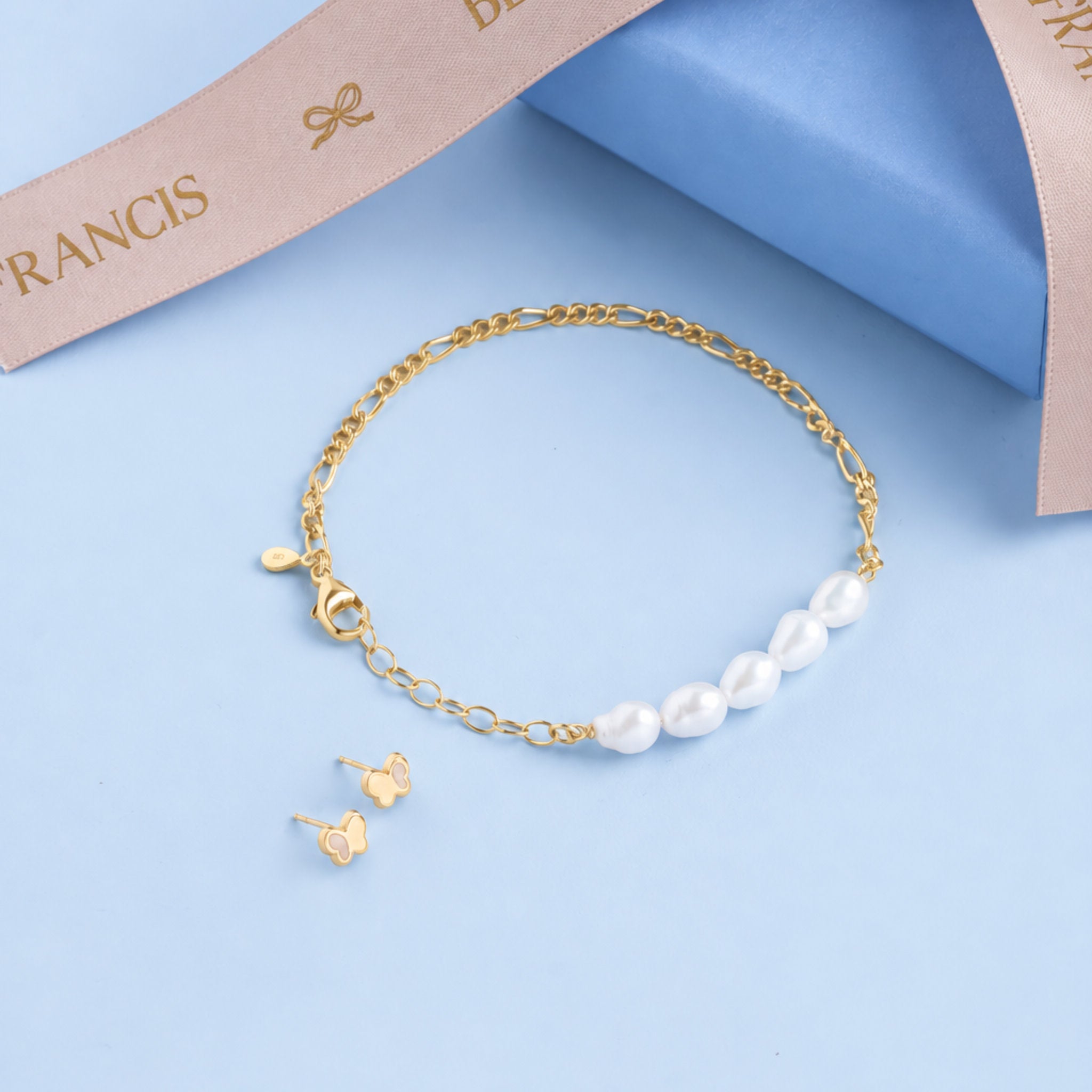 Blue Francis Hudson Pearl Set: freshwater pearl bracelet and gold butterfly stud earrings on blue