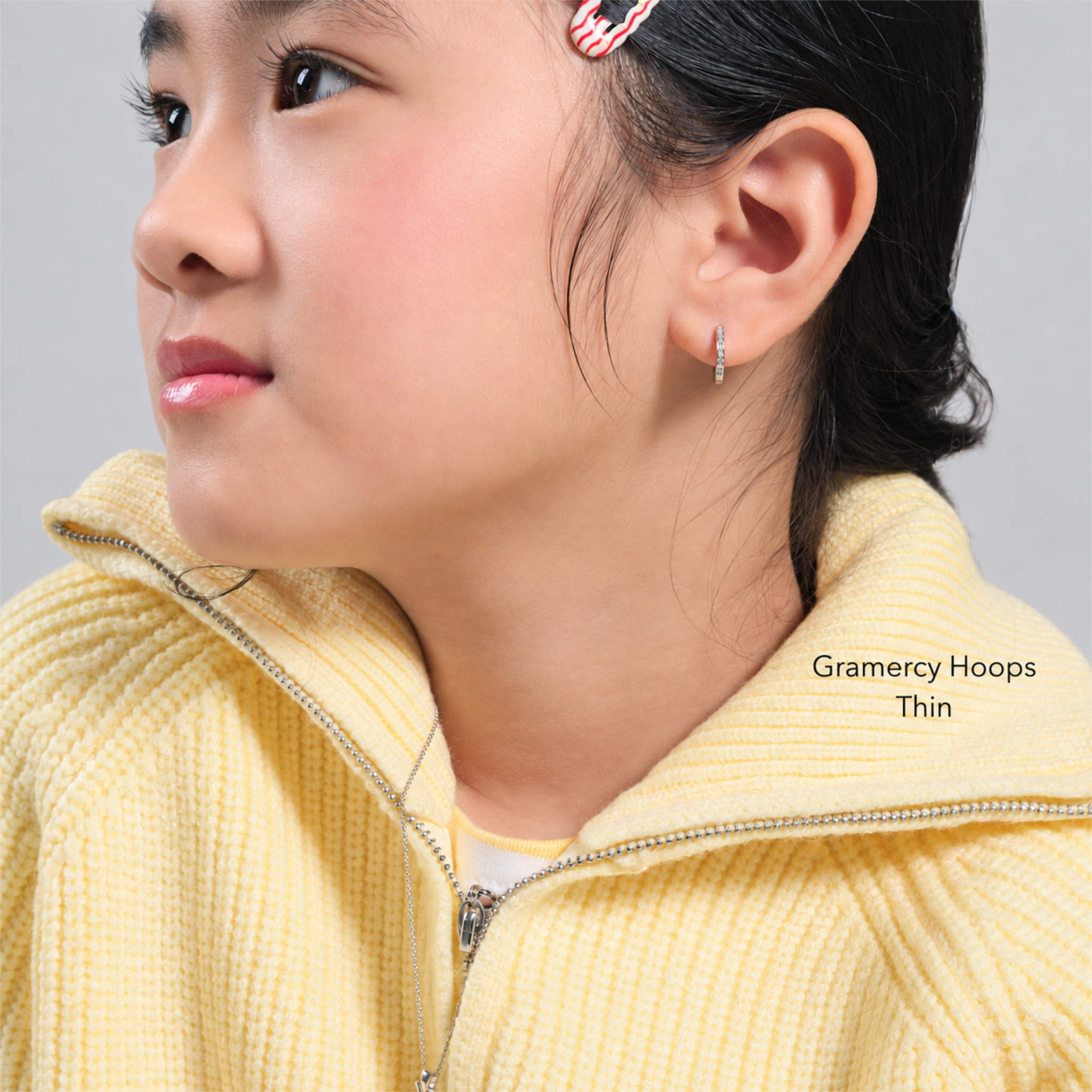 Girl wearing Gramercy Hoops Thin, sterling silver kids hoop earrings with cubic zirconia