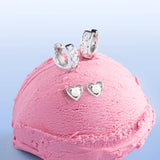 Blue Francis Gramercy Hoops, sterling silver CZ huggie earrings for girls, styled with Brooklyn Heart Pearl studs on a pink ice cream scoop
