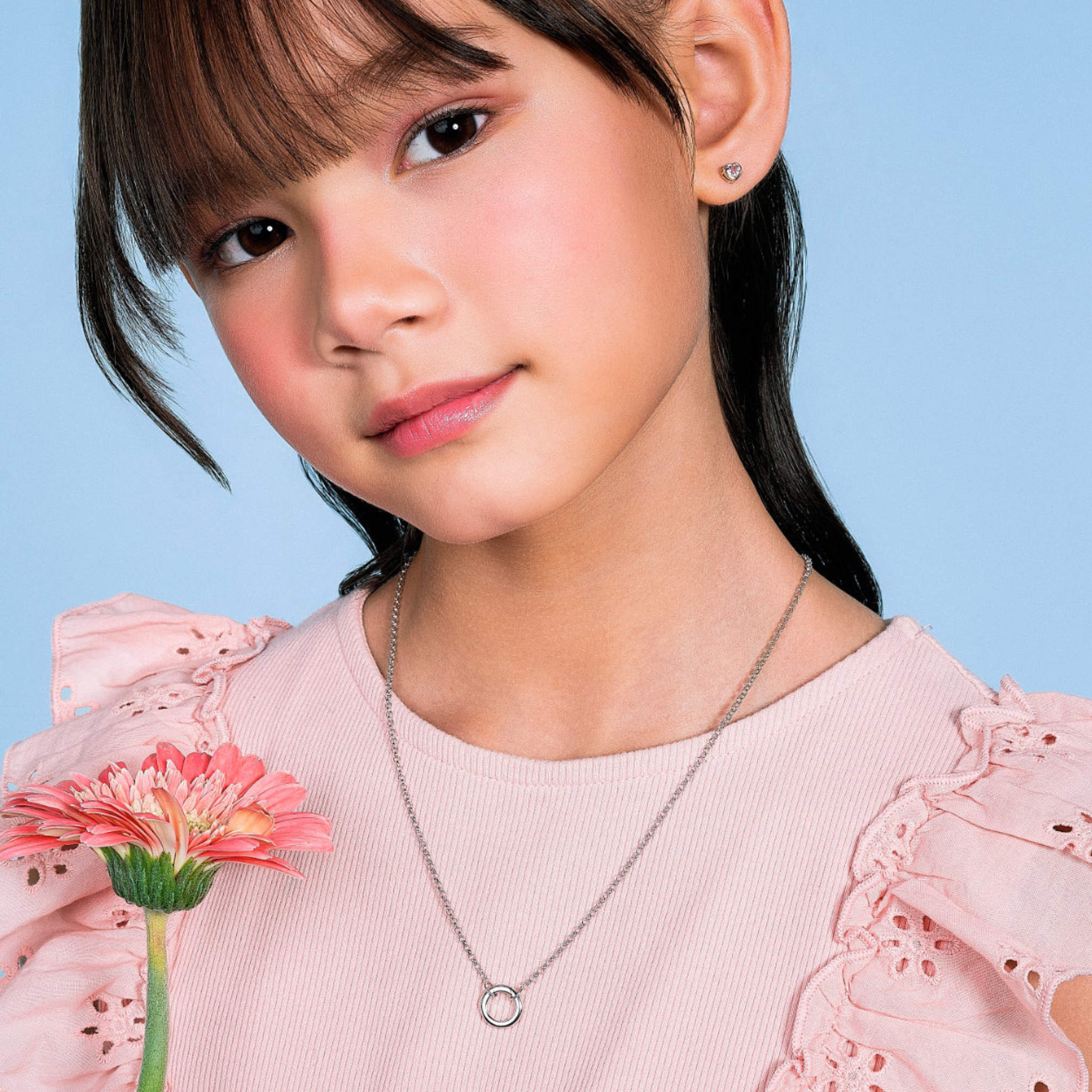 Girl wearing the Blue Francis Liam Circle Clasp Necklace, a silver charm necklace for kids