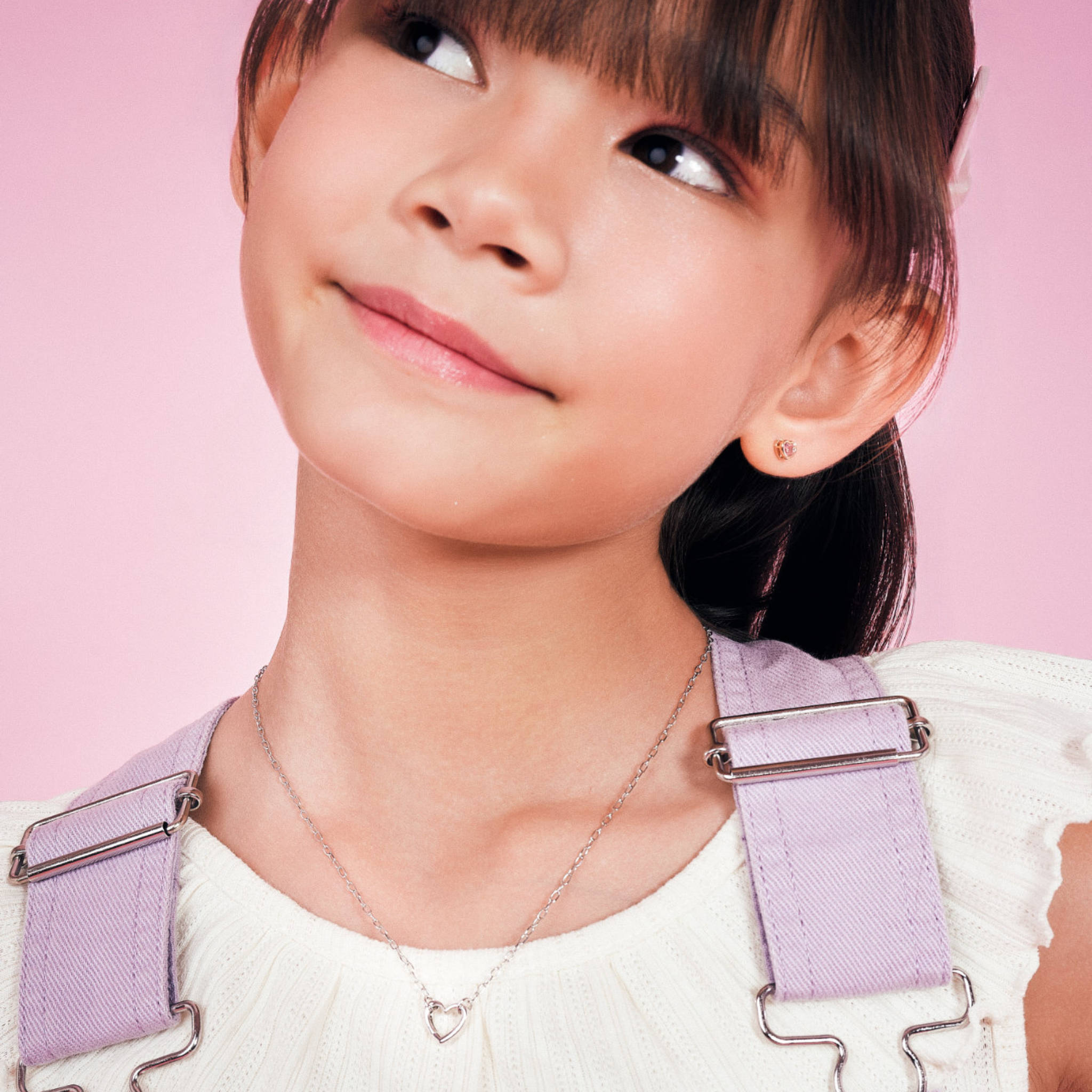 Girl wearing the Blue Francis Liam Heart Clasp Necklace, a sterling silver heart necklace for kids