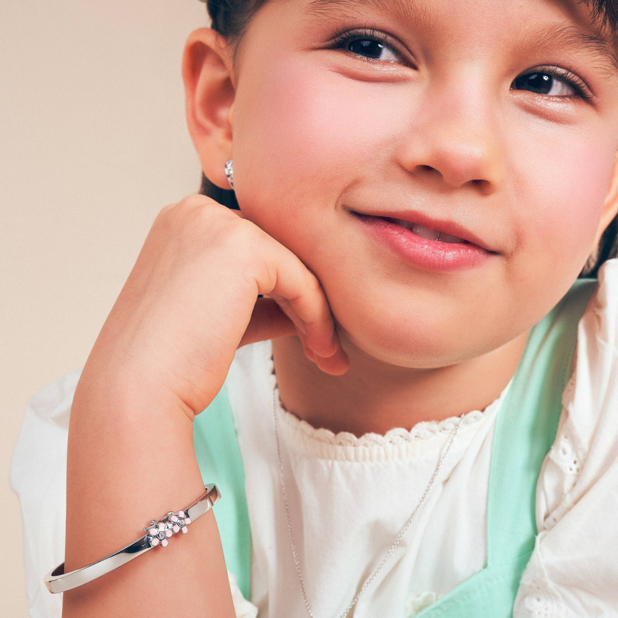Girl wearing the Blue Francis Melodie Pink Fleur Bangle, a sterling silver flower bangle for girls