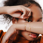 Girl wearing the Twinkle Bracelet, a delicate kids gold bracelet