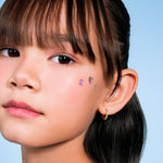 Girl wearing Blue Francis Chelsea Twinkle Hoops, small gold vermeil CZ huggie hoops for kids