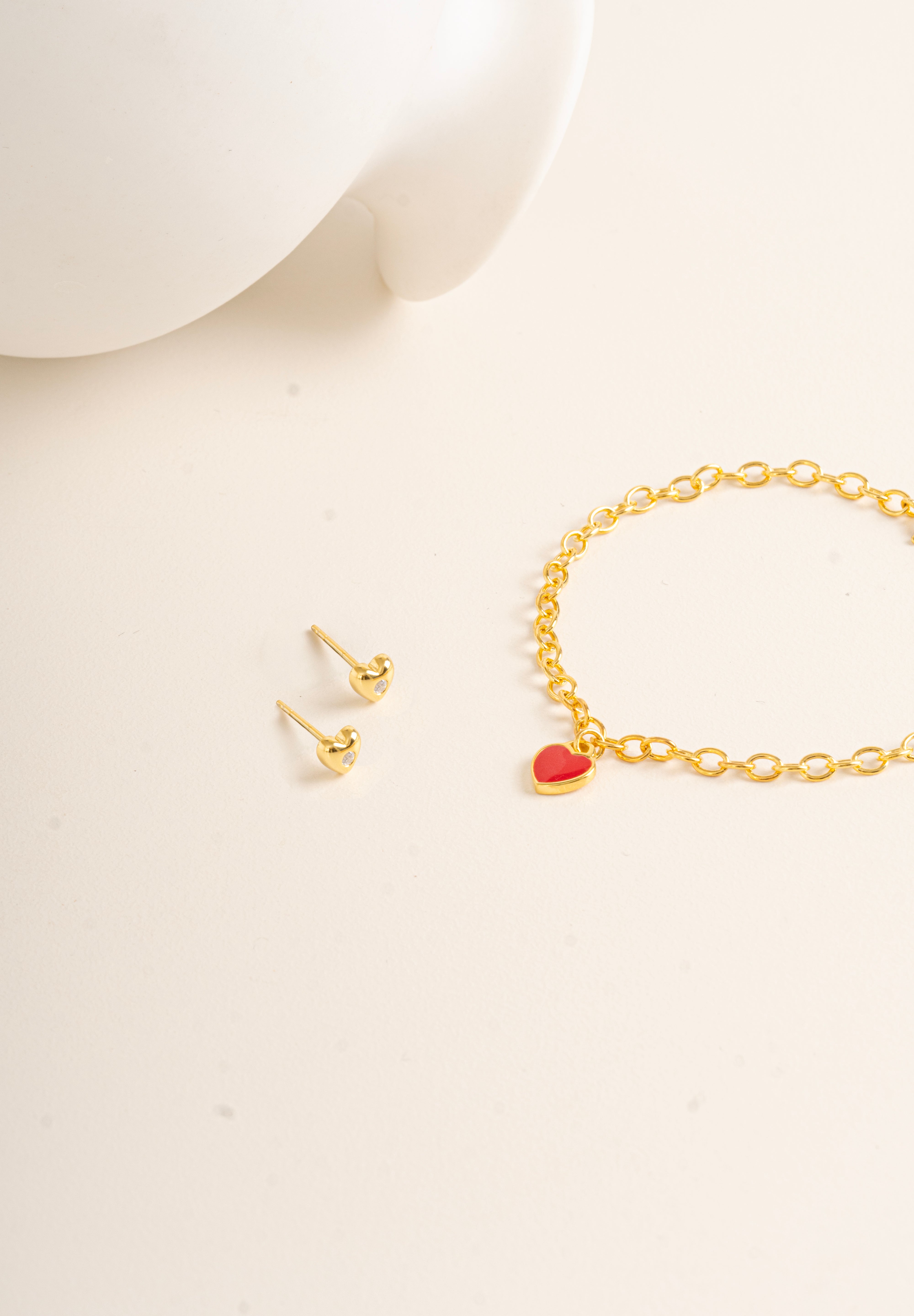 Flat lay picture against cream background for Twinkle Heart Studs and Twinkle Bracelet made out of Vermeil - Blue Francis