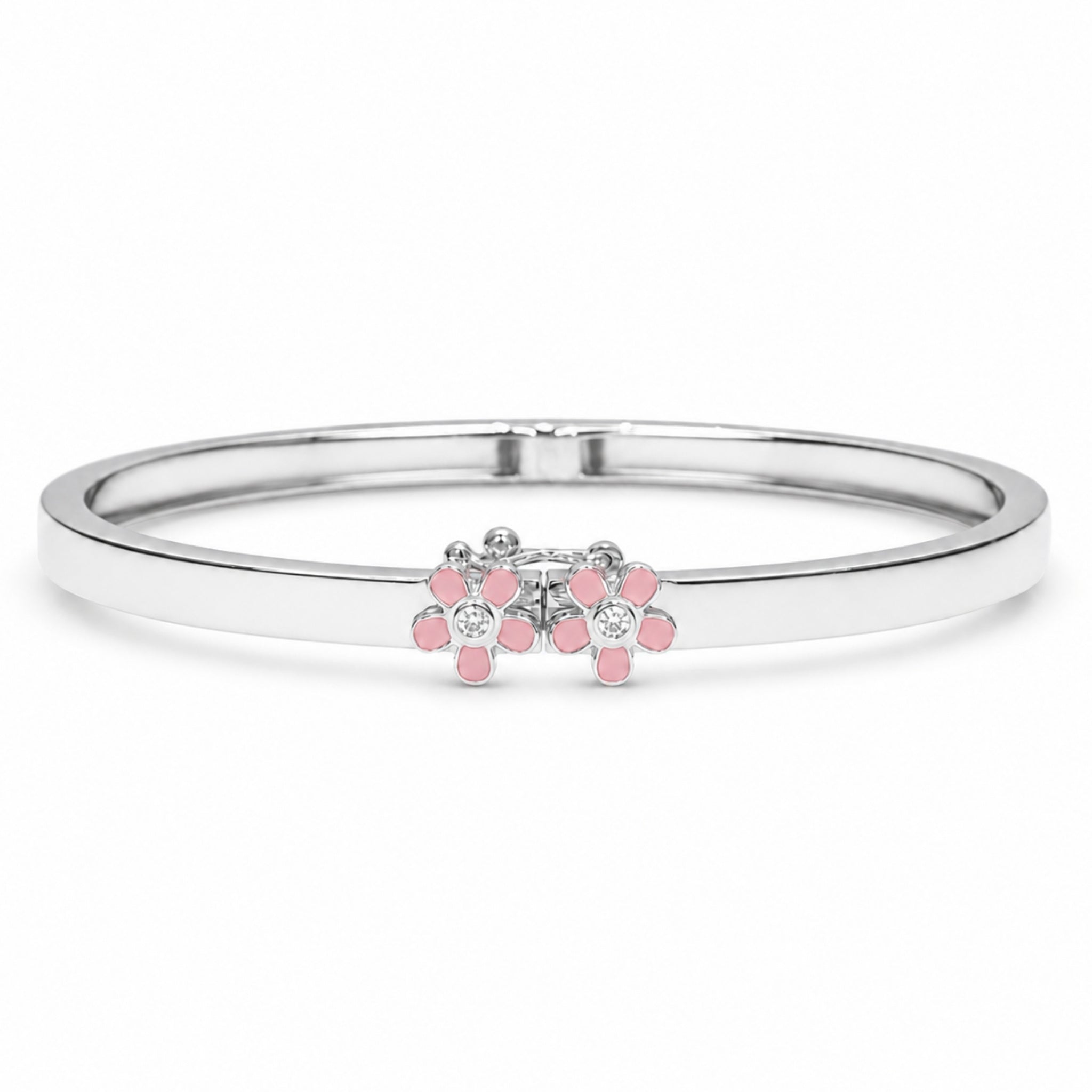 A silver-toned bangle bracelet featuring a small floral cluster centerpiece with pink stones and clear round stones, shown on a plain white background.