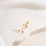 Gold vermeil Twinkle Circle Studs on a white soft cream background in big and small size - Blue Francis
