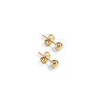 Pair of gold ball stud earrings, called Soho Ball Studs, on a white background.