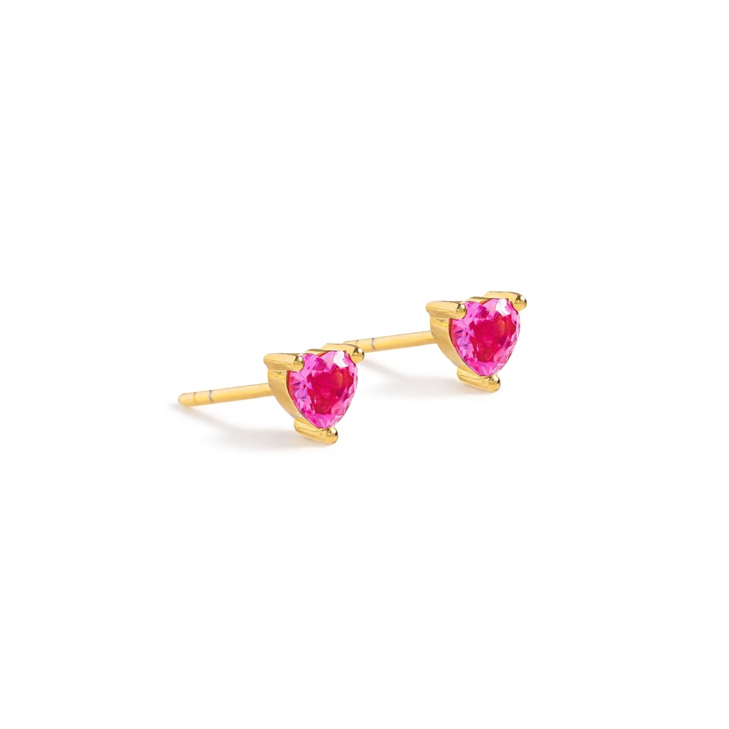 Blue Francis - Ruby Liberty Studs is a Gold heart-shaped earrings with pink gemstones. The earrings is appear on a white background