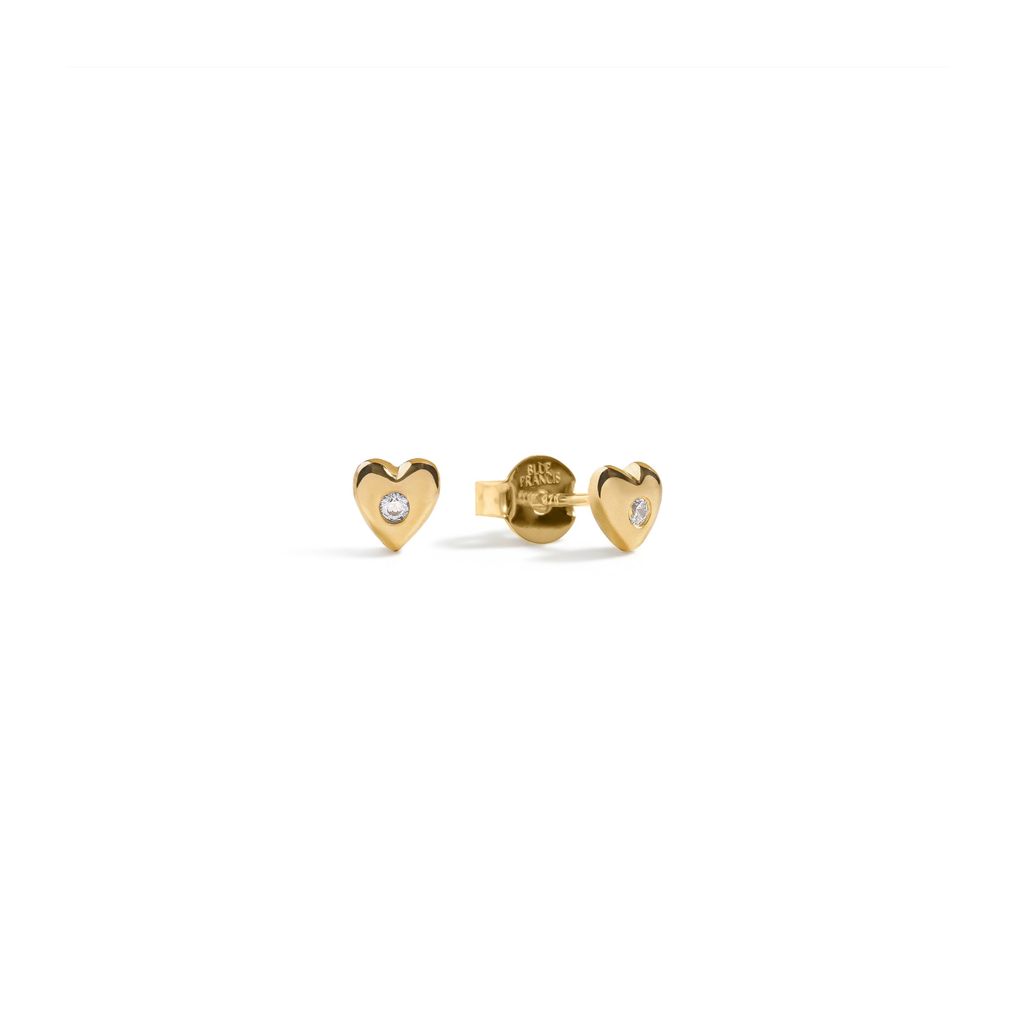 Blue Francis - Twinkle Heart Studs - Heart-shaped gold vermeil earrings with a cz gemstone on a white background