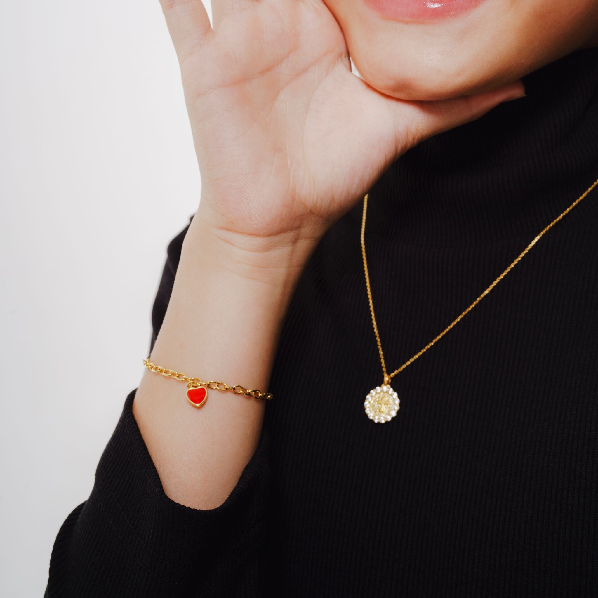 Blue Francis Kids Bracelet made in Vermeil  18K Gold called Red Central Heart Bracelet. In the picture Blue Francis model wearing the bracelet while also wearing a necklace. 