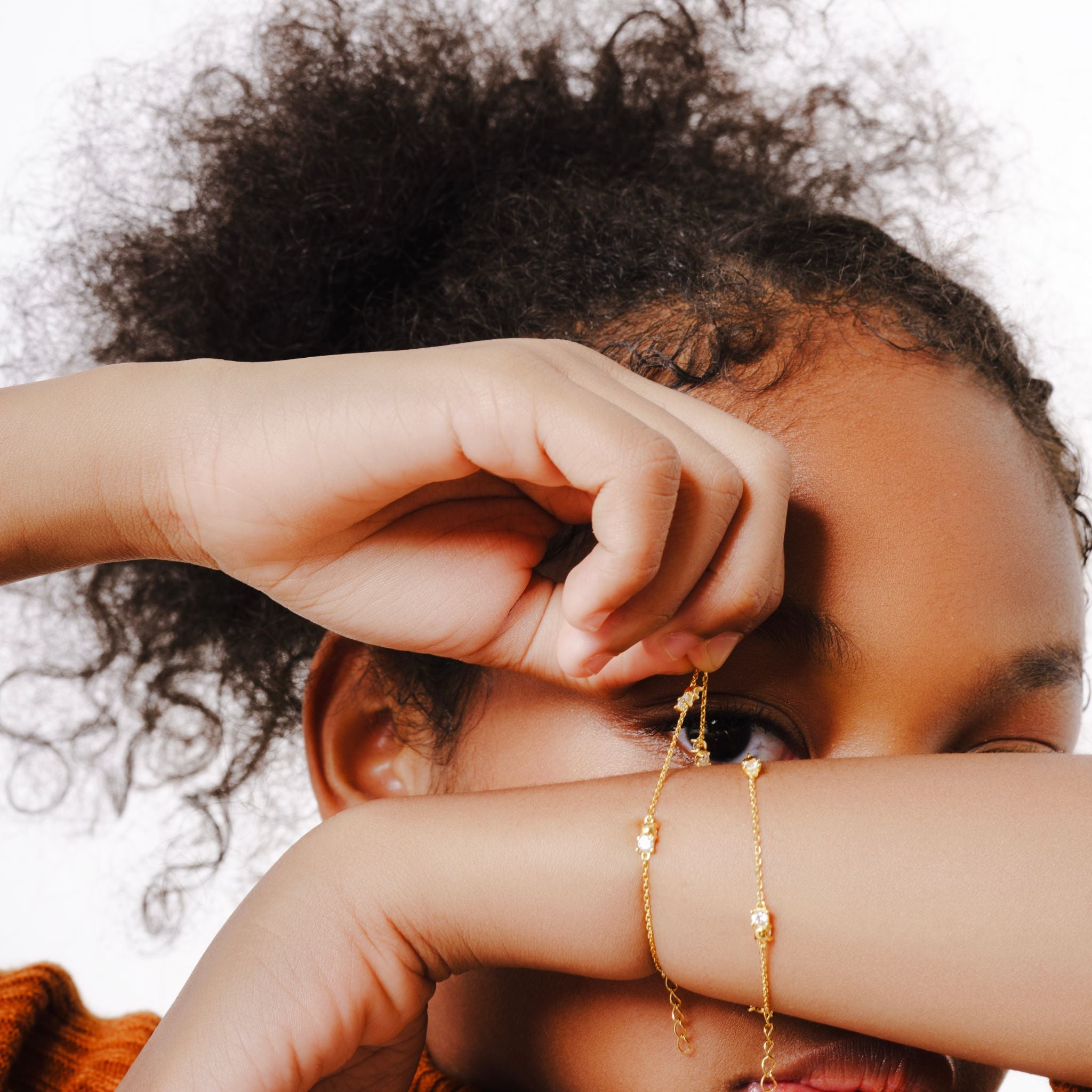 Blue Francis - Kids Bracelet - Vermeil - Twinkle Bracelet. Close-up of a model wearing gold vermeil bracelets with a neutral background
