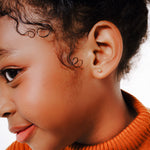 Blue Francis - Kids Stud Earrings - Gold 14K - Soho Ball Studs. A Close-up picture of a child wear a Golden ball studs earring.