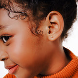 Blue Francis - Kids Stud Earrings - Gold 14K - Soho Ball Studs. A Close-up picture of a child wear a Golden ball studs earring.