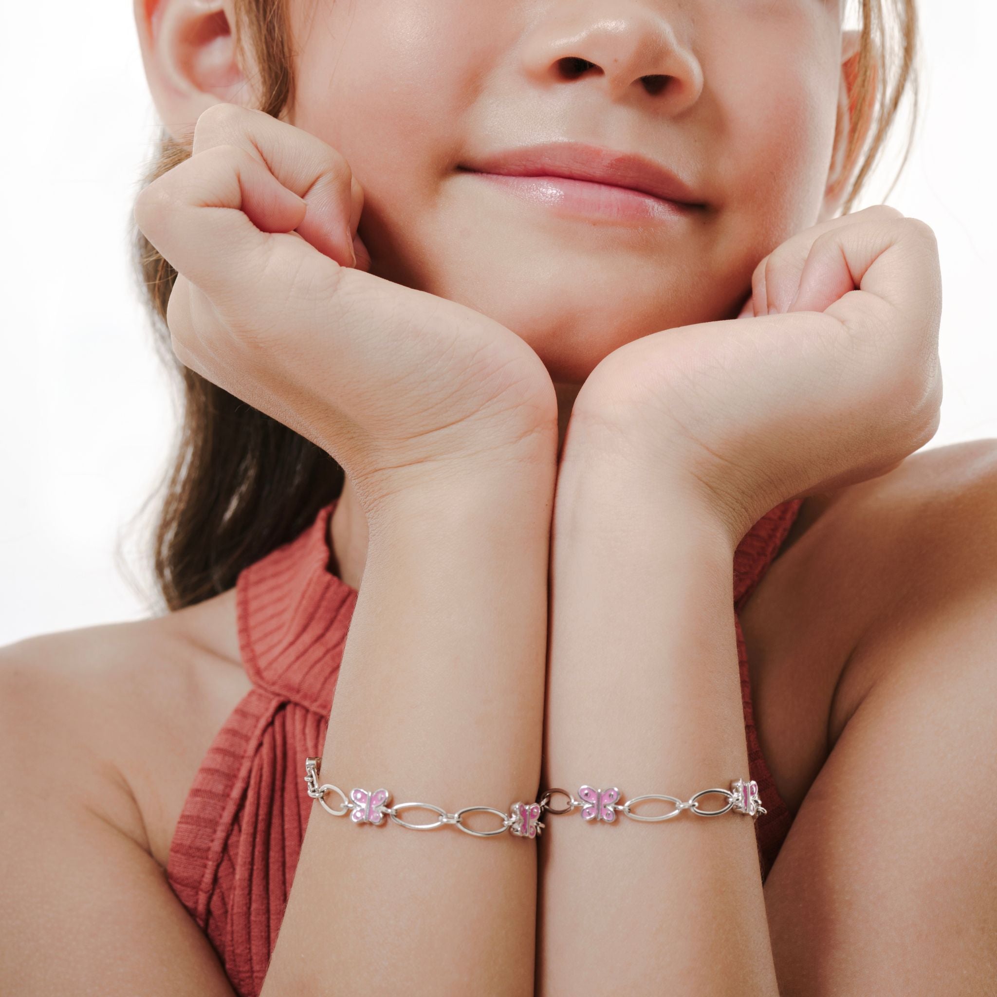 Blue Francis Brooklyn Butterfly Bracelet Close-up of a child wearing a pink bracelet with a white background