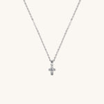 Brooklyn Cross Necklace in sterling silver with cubic zirconia and small heart center, displayed on neutral background for product clarity.