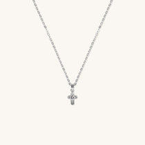 Brooklyn Cross Necklace in sterling silver with cubic zirconia and small heart center, displayed on neutral background for product clarity.