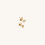Minimalist 14K gold ball stud earrings for children, classic tiny gold sphere studs, hypoallergenic kids' jewelry, versatile first earrings for boys and girls.