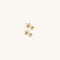 Minimalist 14K gold ball stud earrings for children, classic tiny gold sphere studs, hypoallergenic kids' jewelry, versatile first earrings for boys and girls.