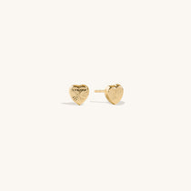 Elegant 14K gold heart stud earrings for children with sunburst pattern, high-quality kids' fine jewelry, polished gold heart-shaped earrings for special occasions.
