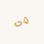 Twinkle Hoops earrings crafted in vermeil with cubic zirconia stones, photographed from a side angle on neutral background for hoop shape detail.