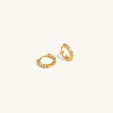 Twinkle Hoops earrings crafted in vermeil with cubic zirconia stones, photographed from a side angle on neutral background for hoop shape detail.