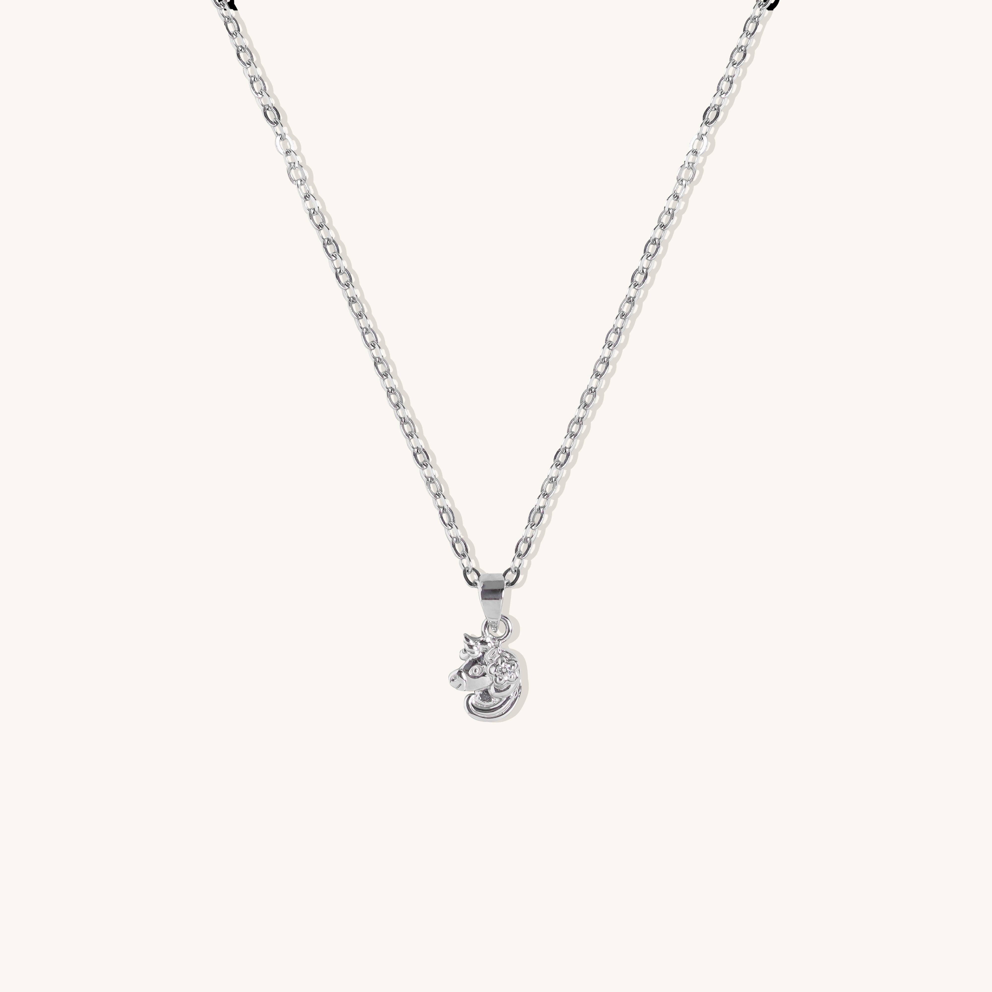 Brooklyn Unicorn Necklace pendant in sterling silver with cubic zirconia on cable chain, displayed flat on neutral background. 